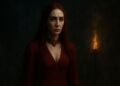 Ultra Hd 2160×3840 Portrait Of Melisandre From Game Of Thrones In Her Crimson Priestess Gown, Illuminated By Torchlight Against A Dark Mystical Backdrop With Glowing Embers