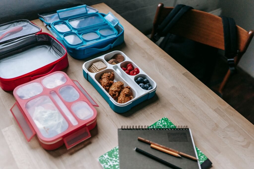 A 3-compartment kids bento lunch box with a balanced meal prepared for school. practical detail