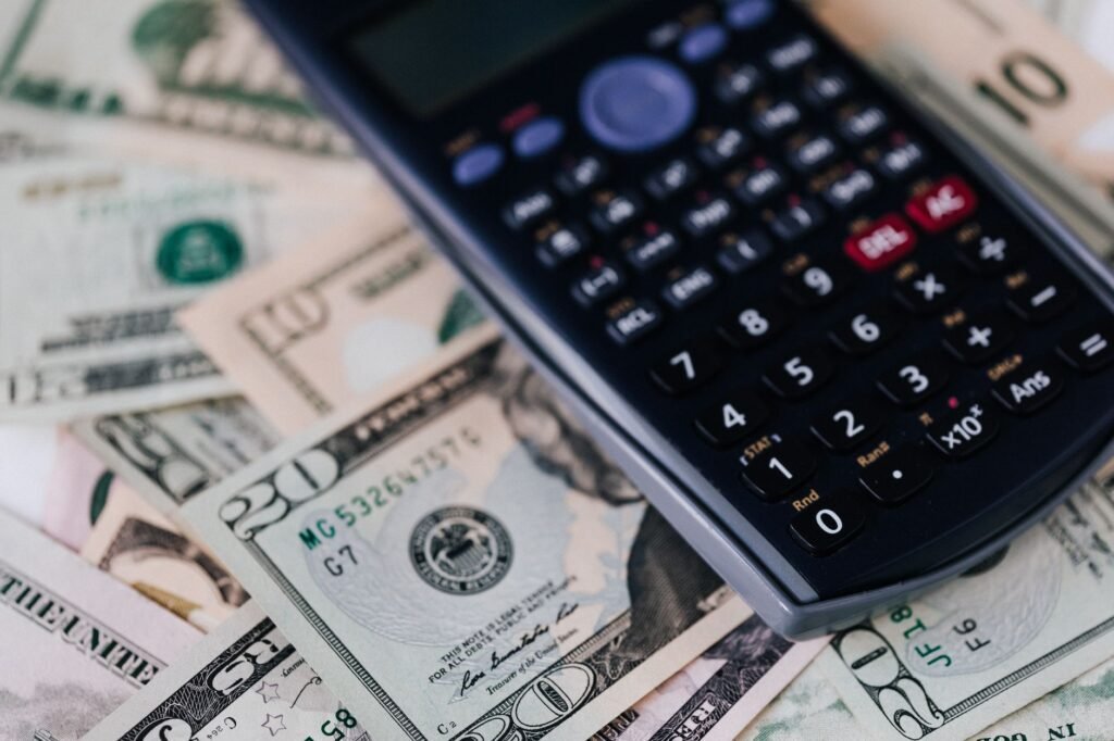 A smartphone displaying a high-yield savings account app next to a jar of coins on a modern desk. practical detail