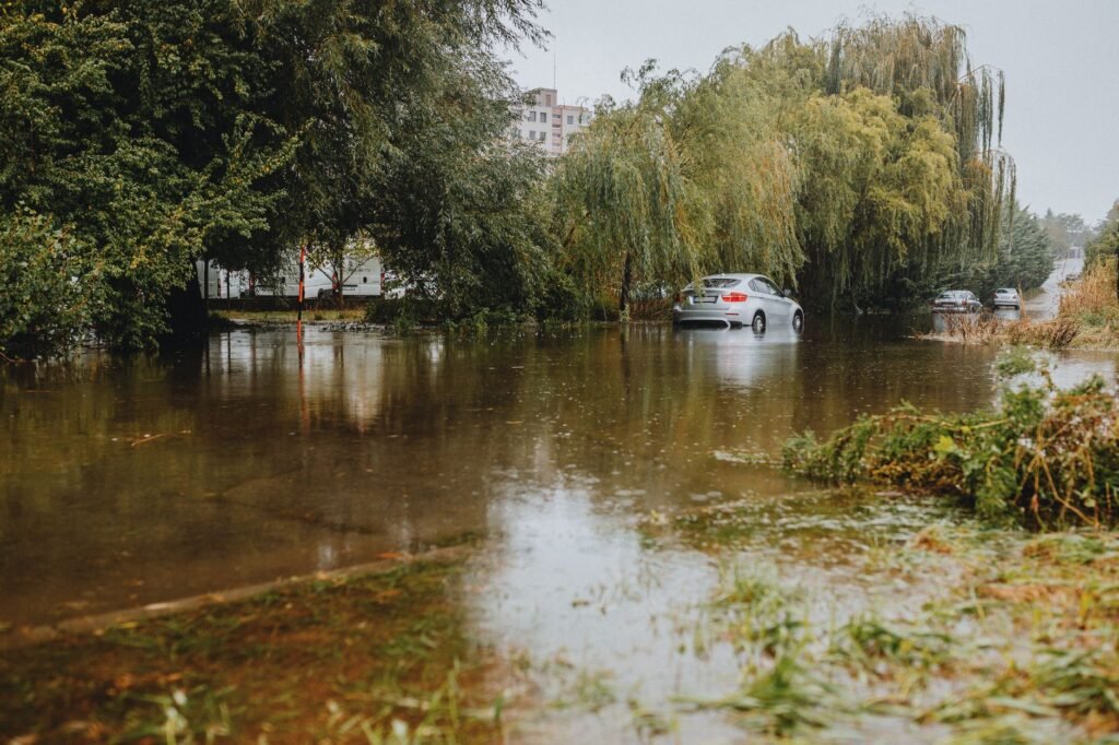 Flooded street in New York's Capital District showing submerged roads and emergency barricades during the 2026 flood recovery. practical detail