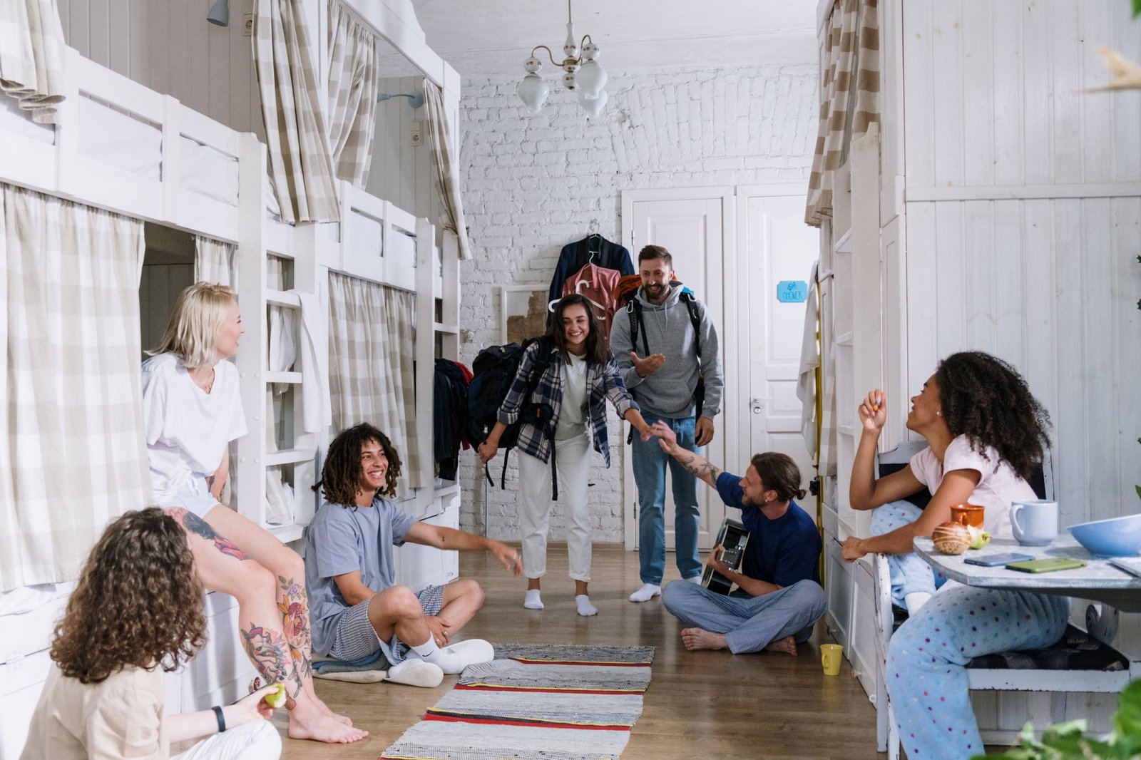 A modern 2026 college dorm room featuring organized bedding, a tech-ready desk, and space-saving storage solutions.