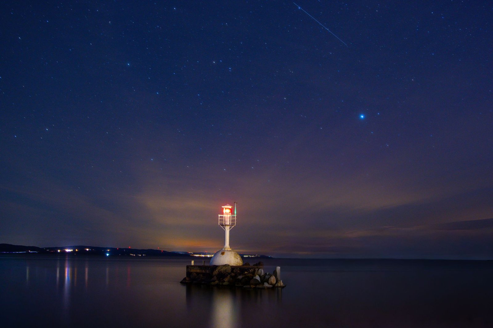 The Delta Aquariid meteor shower 2026 streaking across a dark mountain night sky.