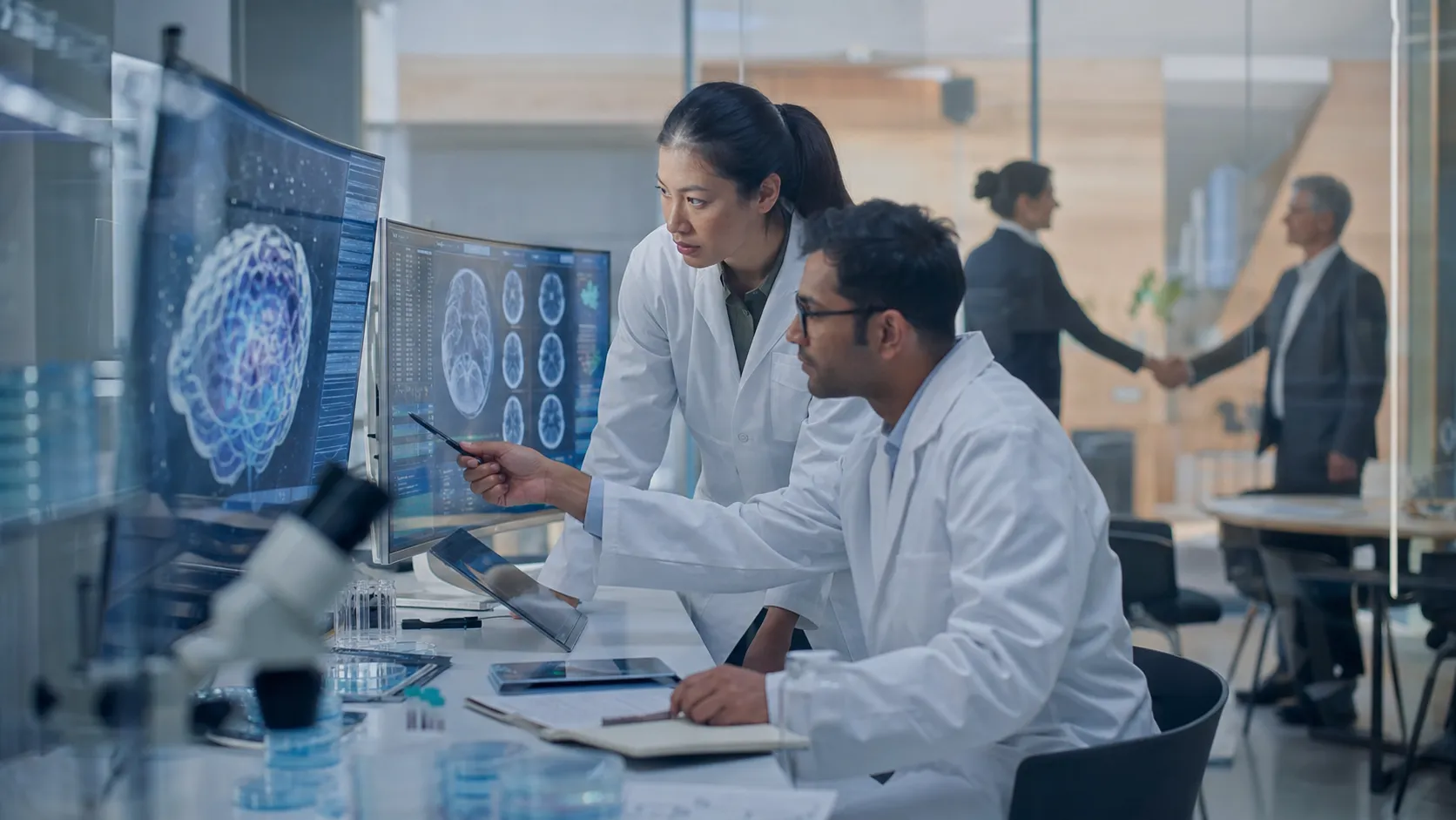 Pharmaceutical researchers reviewing brain scans as a major mental-health drug acquisition is agreed