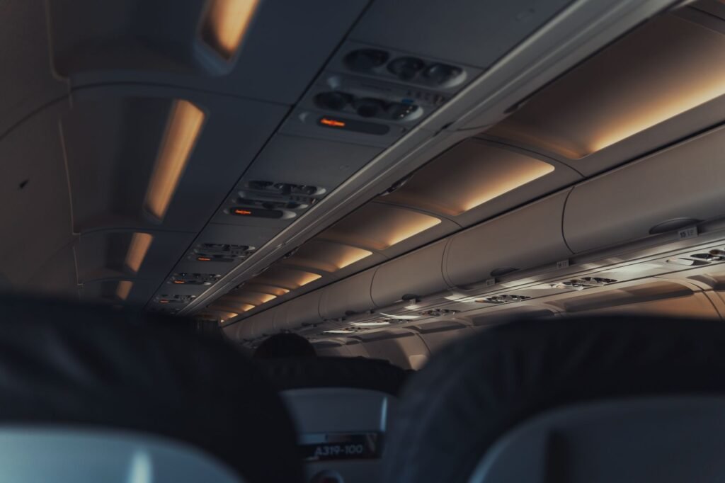 A family sitting together in an airplane row following the 2026 airline family seating rules. practical detail