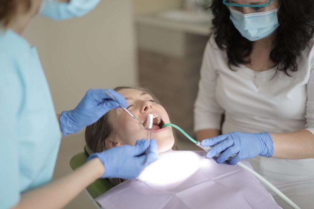 A modern 2026 dental office showing AI diagnostic screens and a laser tool, representing holistic dental care trends. practical detail