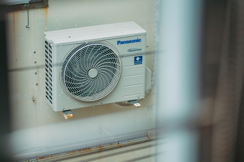 A modern high-efficiency residential heat pump installed outside a home representing the 2026 efficiency standards. practical detail