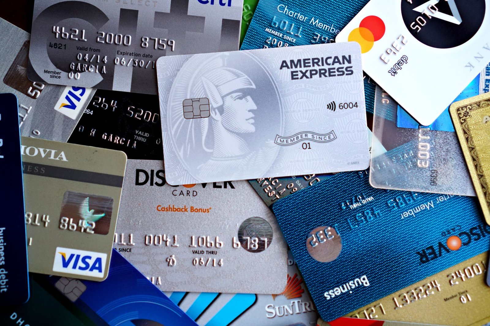 Capital One and Discover credit cards on a desk showing a successful integration notification on a smartphone.