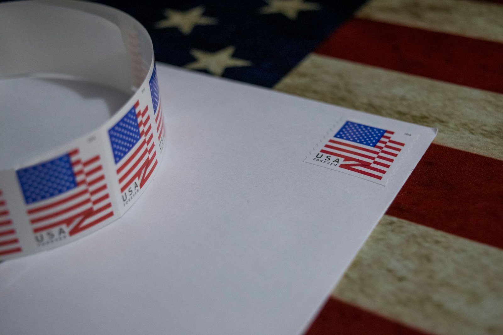 A USPS mail collection box with mail-in ballots being deposited during the 2026 election cycle.