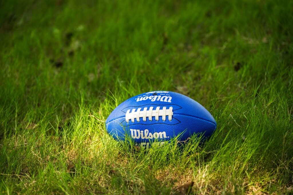 NFL stadium field prepared for a 2026 preseason football game under summer sunlight. practical detail
